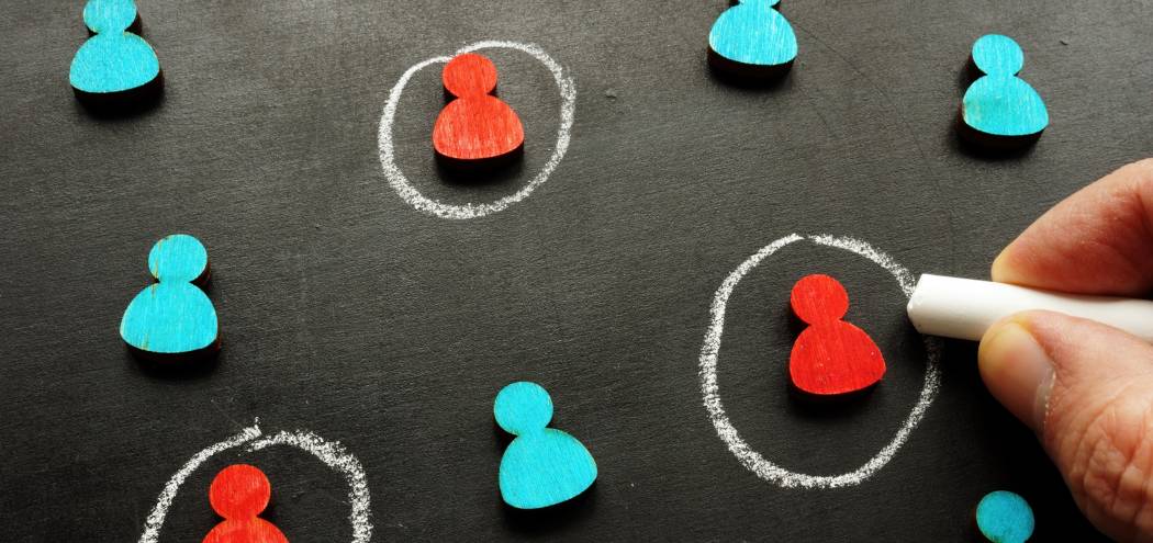 Person highlighting individuals on a chalkboard, representing identifying marketing qualified leads based on engagement